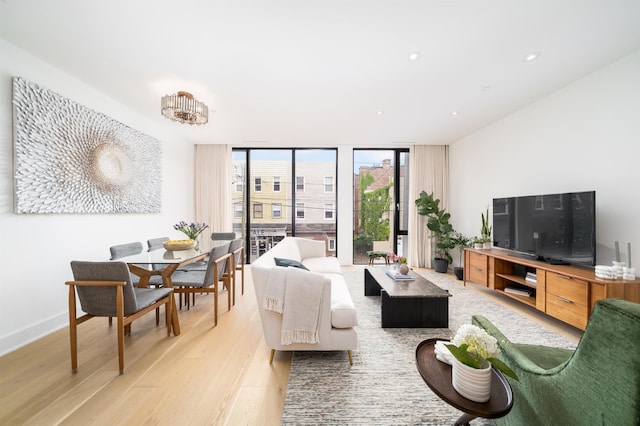48 Coles St Unit 2, Jersey City, NJ 07302 - living area with floor to ceiling windows, light wood-style flooring, recessed lighting, and baseboards