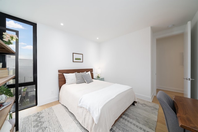 48 Coles St Unit 2, Jersey City, NJ 07302 - bedroom with expansive windows, light wood-style flooring, baseboards, and recessed lighting