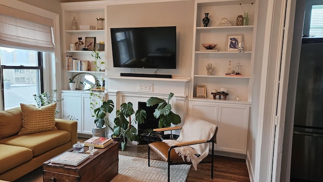 living area with built in features and wood finished floors