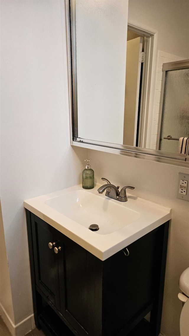 bathroom featuring toilet and vanity