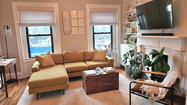 living area featuring wood finished floors, a wealth of natural light, and a fireplace