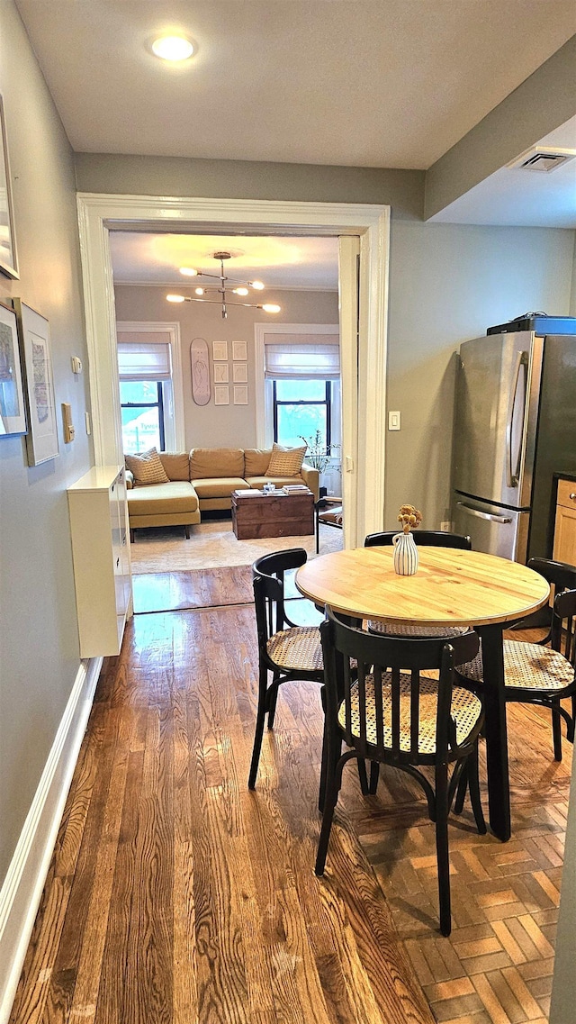 dining area with recessed lighting, visible vents, and wood finished floors