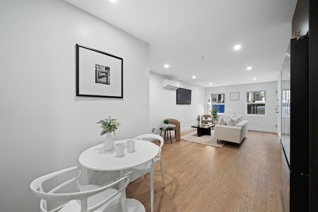 20 Storms Ave Unit 1A, Jersey City, NJ 07306 - dining area featuring a wall mounted AC, recessed lighting, light wood-style flooring, and baseboards