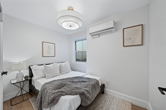 20 Storms Ave Unit 1A, Jersey City, NJ 07306 - bedroom featuring a wall mounted air conditioner, wood finished floors, and baseboards