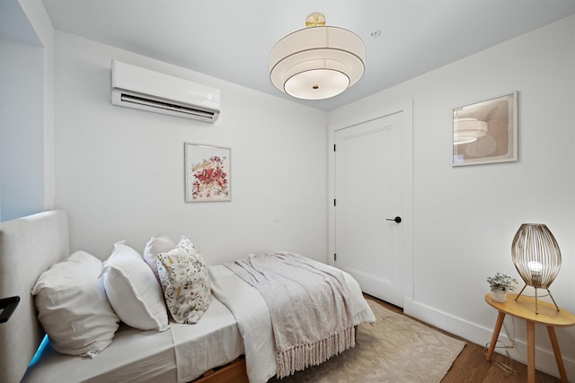 20 Storms Ave Unit 1A, Jersey City, NJ 07306 - bedroom featuring a wall mounted AC, wood finished floors, baseboards, and a closet