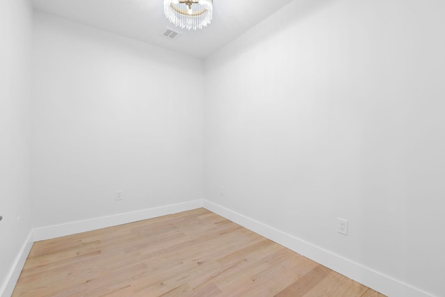 unfurnished room featuring visible vents, baseboards, and light wood finished floors