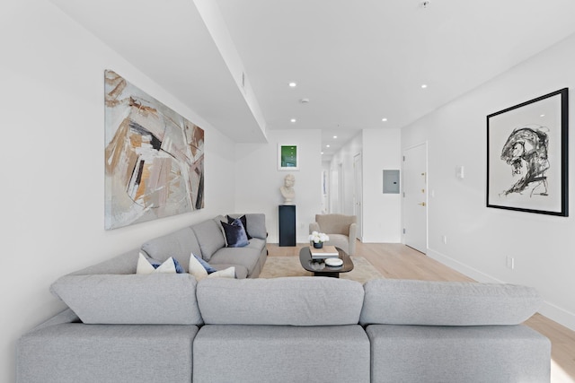 living area with recessed lighting, baseboards, and light wood-style floors