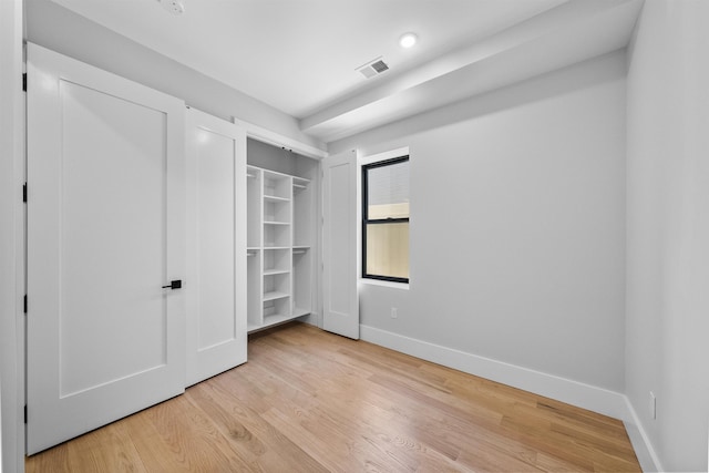 unfurnished bedroom with baseboards and light wood finished floors