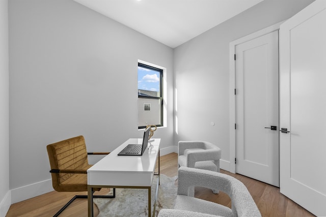 office space with wood finished floors and baseboards