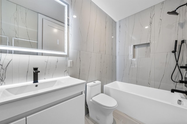 bathroom featuring toilet, vanity, tub / shower combination, and tile walls