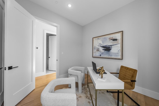 office space featuring baseboards, light wood-style flooring, and recessed lighting