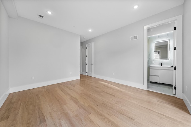unfurnished room with light wood finished floors, baseboards, and recessed lighting