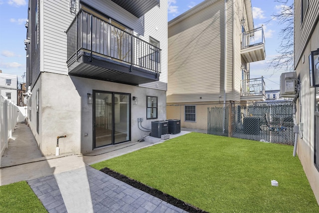 rear view of house with a balcony, stucco siding, and cooling unit