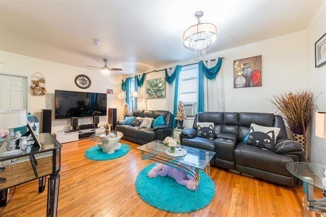 living room featuring hardwood / wood-style floors and ceiling fan