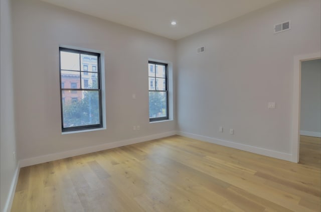 unfurnished room with plenty of natural light and light wood-type flooring