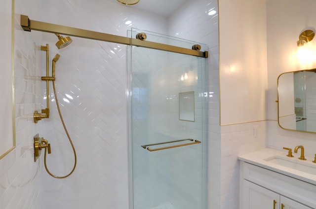 bathroom with vanity, tile walls, and walk in shower