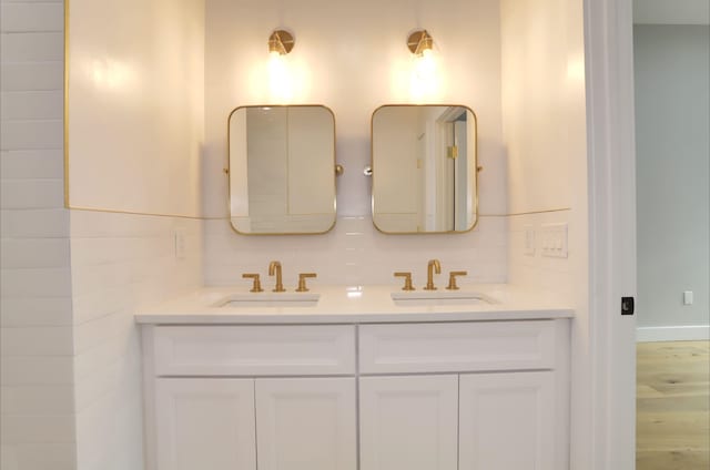 bathroom featuring vanity and decorative backsplash