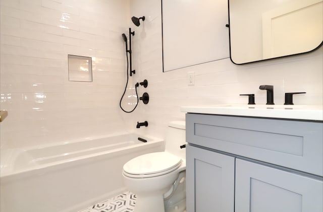 full bathroom featuring vanity, toilet, tiled shower / bath combo, and tile patterned flooring