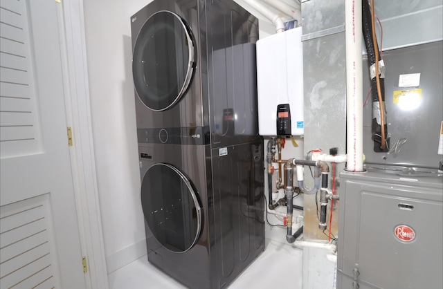 washroom featuring stacked washer / dryer and tankless water heater