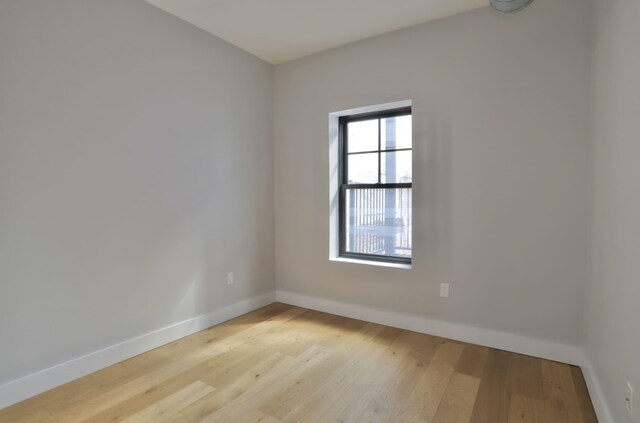 spare room featuring plenty of natural light and light hardwood / wood-style floors