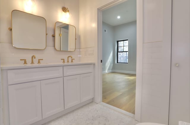 bathroom with tasteful backsplash and vanity