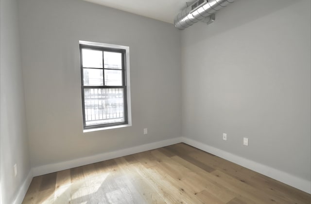 spare room featuring light hardwood / wood-style flooring and a wealth of natural light