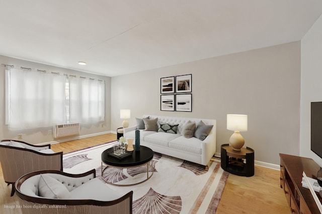 310 70th St Unit 1D, Guttenberg, NJ 07093 - living area featuring wood finished floors, baseboards, and a wall unit AC