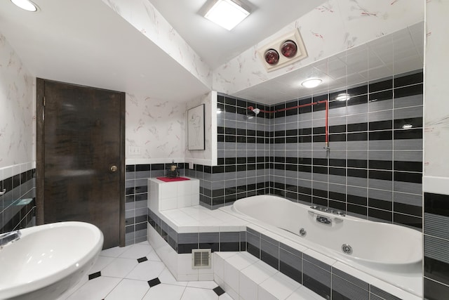 bathroom with sink, tile walls, and tiled bath