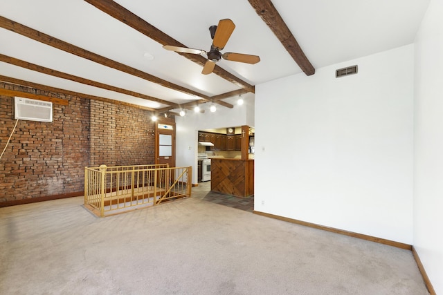 spare room featuring ceiling fan, beam ceiling, a wall mounted air conditioner, carpet floors, and brick wall