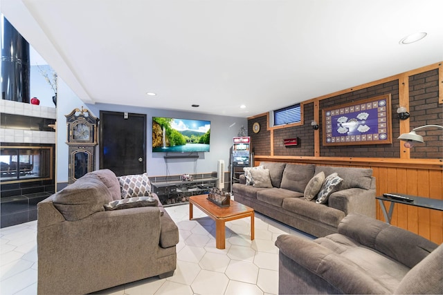 tiled living room featuring a tiled fireplace