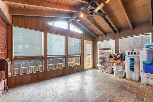 unfurnished sunroom with ceiling fan, wooden ceiling, and vaulted ceiling with beams