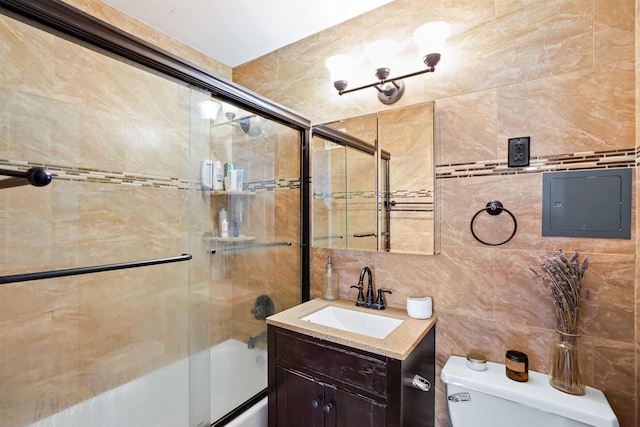full bath with vanity, toilet, enclosed tub / shower combo, tile walls, and tasteful backsplash