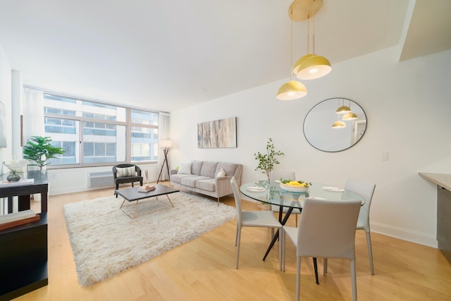 living area with light wood-style floors and baseboards