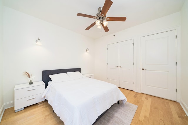 bedroom featuring a closet, ceiling fan, light wood-style flooring, and baseboards