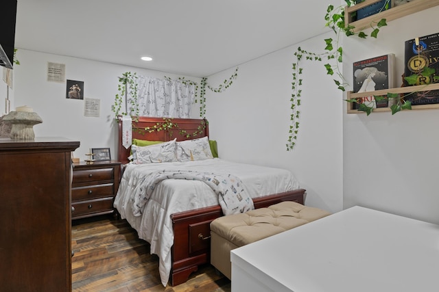 bedroom with dark hardwood / wood-style flooring