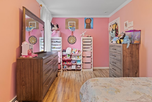 bedroom featuring crown molding, a baseboard radiator, and light wood-type flooring