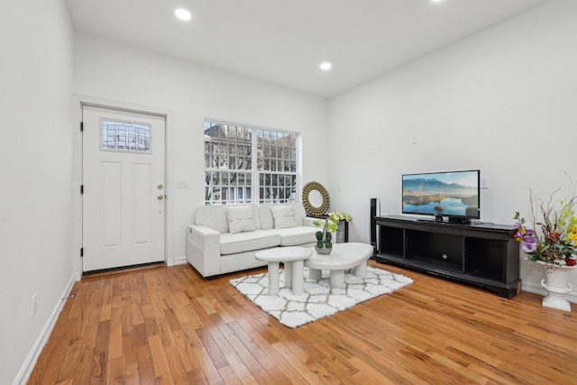 living area featuring hardwood / wood-style floors, recessed lighting, and baseboards
