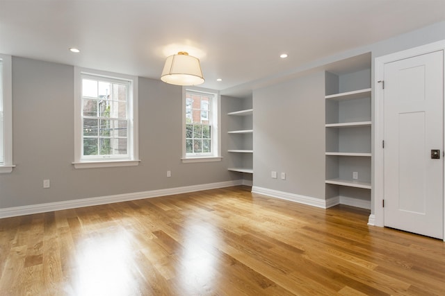 interior space with light wood-style flooring, built in features, recessed lighting, and baseboards