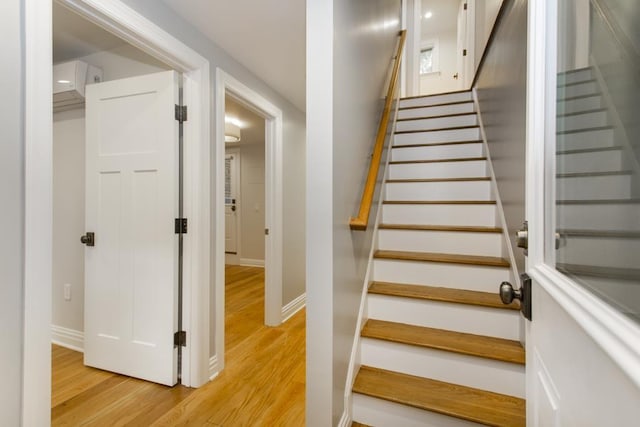 stairway featuring wood finished floors and baseboards