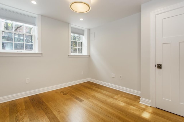 unfurnished room featuring recessed lighting, light wood-type flooring, and baseboards