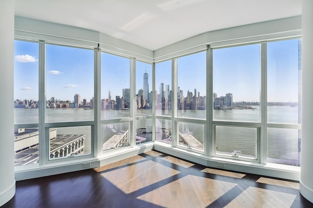 sunroom with a city view and a water view