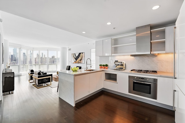 kitchen with island exhaust hood, a peninsula, open shelves, modern cabinets, and stainless steel appliances