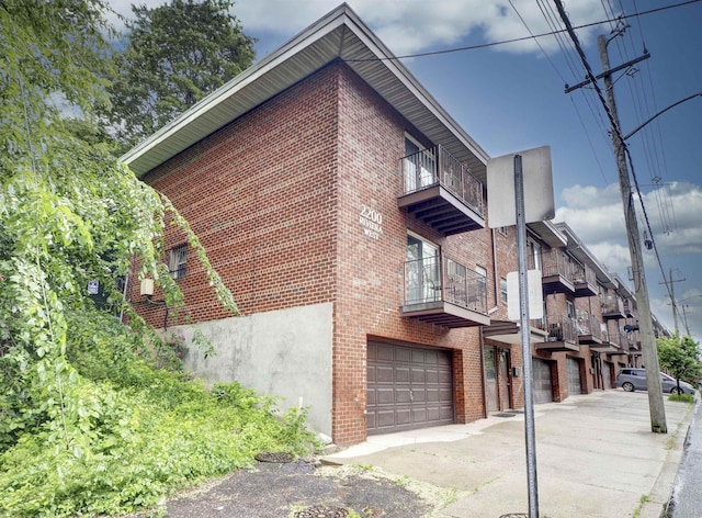 2200 Paterson Plank Rd Unit 19, North Bergen, NJ 07047 - view of building exterior featuring an attached garage and driveway