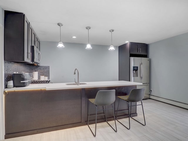 2200 Paterson Plank Rd Unit 19, North Bergen, NJ 07047 - kitchen featuring stainless steel appliances, a sink, a peninsula, decorative backsplash, and a breakfast bar