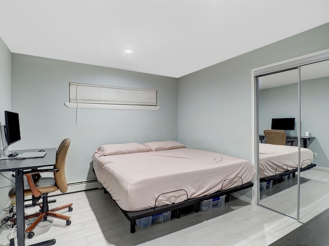2200 Paterson Plank Rd Unit 19, North Bergen, NJ 07047 - bedroom with a closet, an office area, light wood-style floors, recessed lighting, and a baseboard heating unit