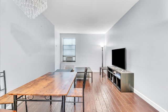 294 Barrow St Unit 6, Jersey City, NJ 07302 - dining room featuring cooling unit, a chandelier, and wood finished floors