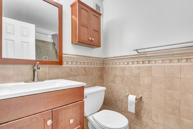 294 Barrow St Unit 6, Jersey City, NJ 07302 - bathroom featuring vanity, tile walls, and wainscoting