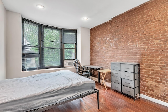 294 Barrow St Unit 6, Jersey City, NJ 07302 - bedroom featuring brick wall, wood finished floors, cooling unit, and recessed lighting