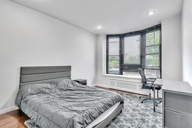 294 Barrow St Unit 6, Jersey City, NJ 07302 - bedroom featuring a desk, recessed lighting, wood finished floors, and radiator heating unit