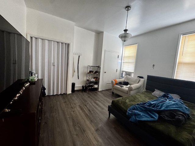 bedroom with a baseboard radiator and dark hardwood / wood-style floors